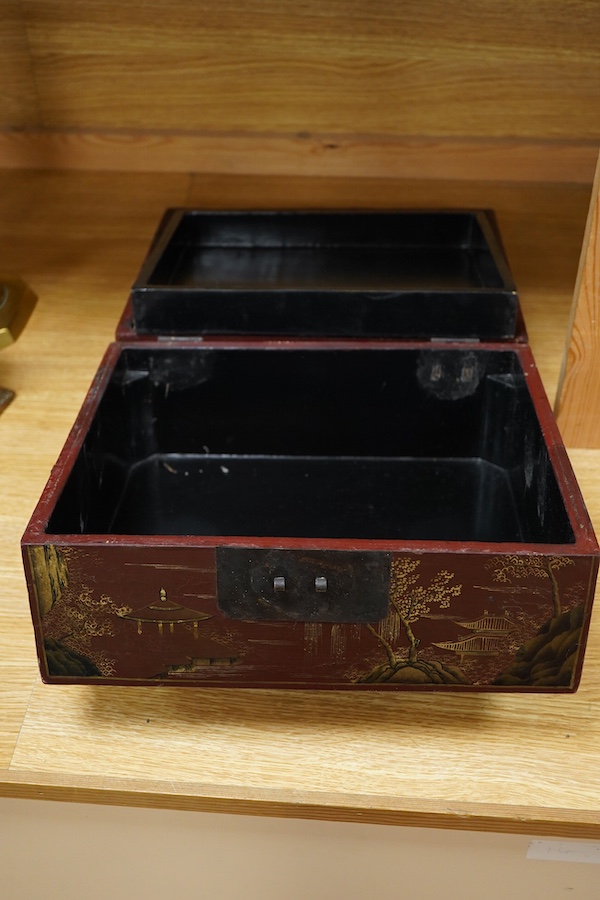 A Chinese lacquered box decorated with relief figures, 33cm wide